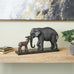 Deco 79 Resin Elephant Decorative Sculpture Walking Home Decor Statue with Dark Brown Deer, Accent Figurine 20" x 6" x 11", Black